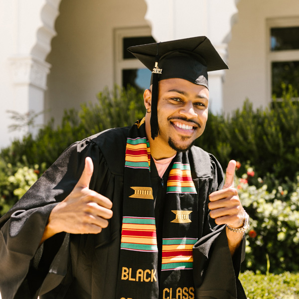 College graduate giving the thumbs up